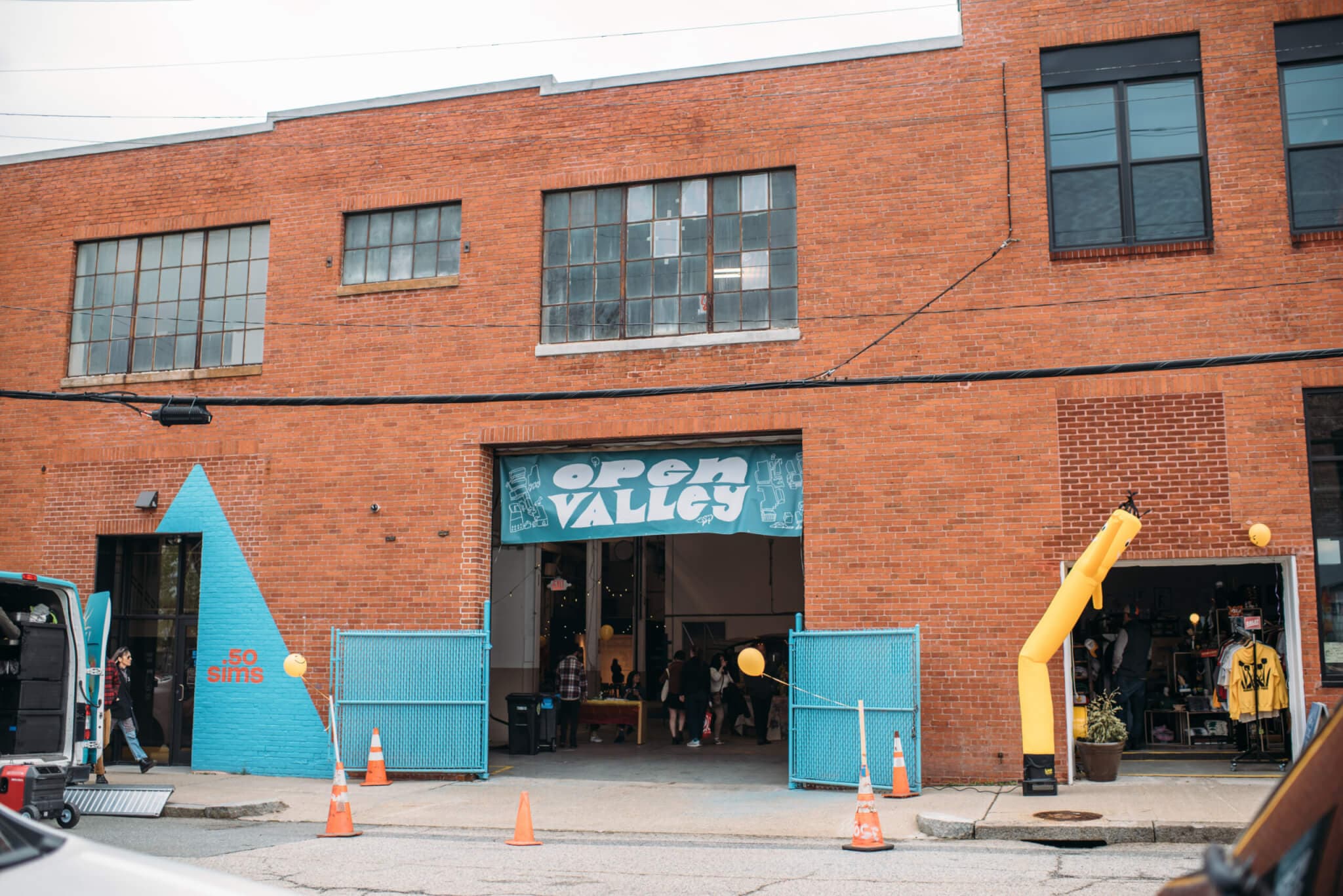 Exterior view of a brick building with a blue sign that reads "Open Valley."